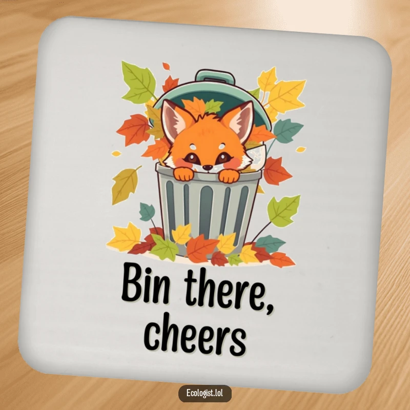 Funny fox cub peeking from a recycling bin with colorful leaves on a drink coaster, adding natural humor.